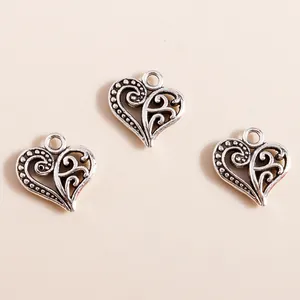 Set of vintage silver hollow heart alloy charms with scroll pattern for DIY jewelry