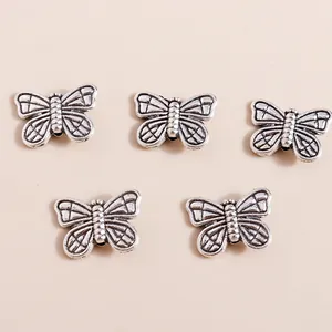 Five vintage silver alloy butterfly pendants for DIY jewelry making and craft projects