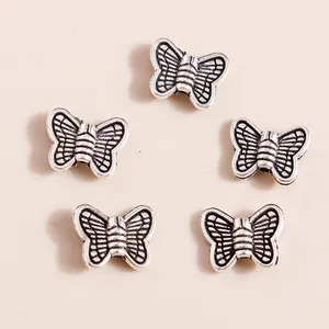 Five antique silver butterfly charms made of plated alloy for DIY jewelry making and crafts