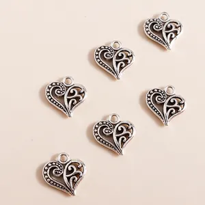 Retro silver alloy hollow heart pendants with vintage filigree design for DIY jewelry