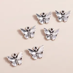 Set of 6 vintage silver alloy butterfly charms with intricate embossed texture for DIY jewelry