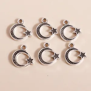 Macro shot of vintage silver moon and star alloy pendants with detailed textured finish