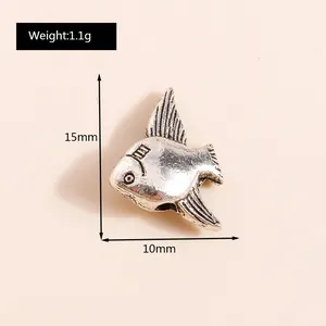 Macro detail of 15mm antique silver fish pendant with precise size measurements