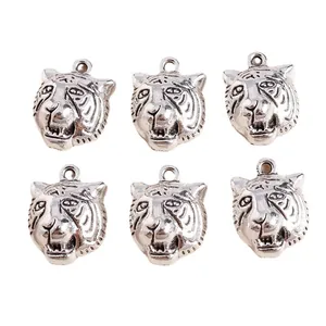 Detail of vintage silver tiger head charms with 3D relief for DIY jewelry making