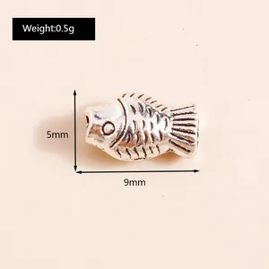 Detail view showing 5mm by 9mm vintage silver koi fish pendant with weight of 0.5g