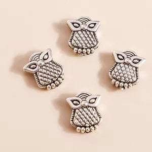 Detailed view of four vintage silver owl alloy charms for jewelry DIY crafts