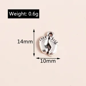 Macro shot of silver alloy baby footprint pendant showing 14mm height and 10mm width
