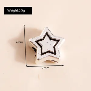 Macro shot of 7mm silver alloy star pendant showing detailed 0.5g weight and size