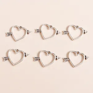 Macro shot of silver plated heart and arrow charms for DIY jewelry making sets