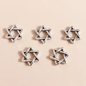 Close-up of vintage silver plated alloy hexagram charms for DIY jewelry making