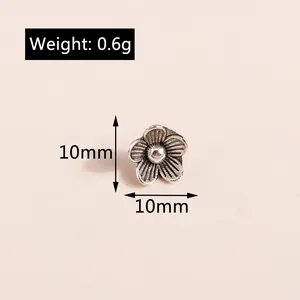 Macro view of 10mm vintage silver flower pendant with weight 0.6g for DIY jewelry