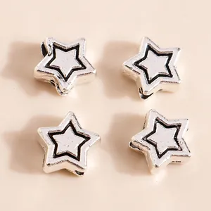Macro detail of star-shaped antique silver alloy beads for DIY jewelry making