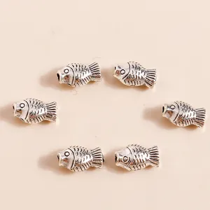 Antique silver koi fish charms for jewelry making with detailed scales and fin textures