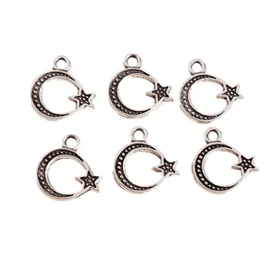 Macro detail of retro silver plated alloy star and moon charms for DIY jewelry making