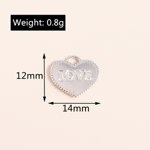 Detail of silver heart charm with LOVE engraving, 12mm x 14mm size and 0.8g weight specs