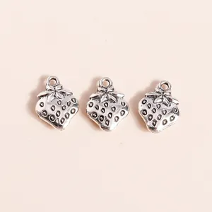 Detailed view of silver alloy strawberry charms for DIY jewelry making with textured seeds
