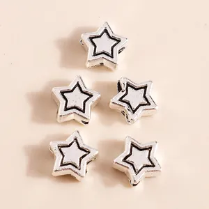 Five vintage silver alloy star pendants for DIY jewelry making in a minimalist layout