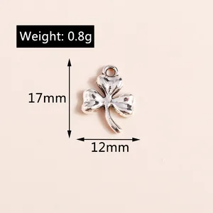 Macro detail of silver clover pendant charms showing 17mm size and heart shaped leaves