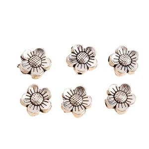 Detailed view of vintage silver sunflower alloy beads for DIY jewelry making and crafts
