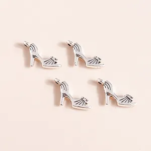 Macro shot of 4 vintage silver alloy high heel charms with detailed openwork for DIY jewelry