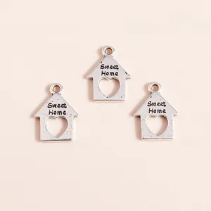 Detail of silver alloy house pendants with Sweet Home engraving and heart cutout