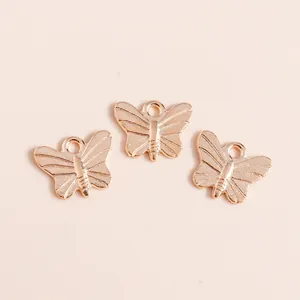 Macro shot of three gold butterfly charms with detailed texture for DIY jewelry making