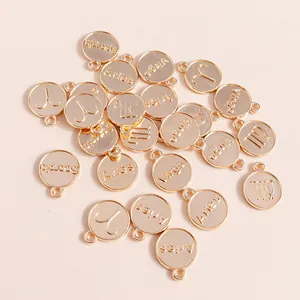 Detailed macro view of golden plated zodiac charms with engraved names and constellation symbols