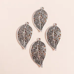 Vintage hollow leaf charms in antique silver alloy for DIY jewelry and necklaces