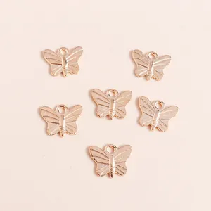 Six rose gold butterfly alloy pendants with wing textures for DIY jewelry making