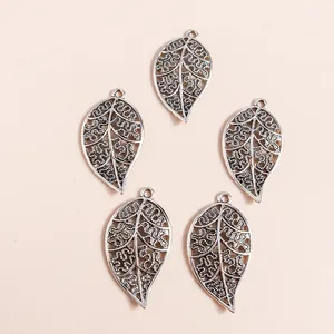 Five vintage silver hollow leaf charms made of alloy for DIY jewelry crafting accessories