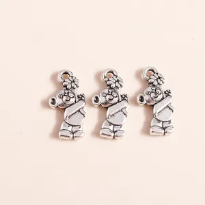 Detailed close-up of three silver-plated bear charms with intricate floral engravings