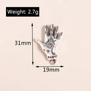 Macro view of vintage silver hamsa hand pendant with all-seeing eye and size measurements