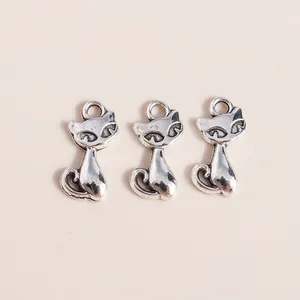 Detailed close-up of three vintage silver alloy cat-shaped charms for DIY jewelry making
