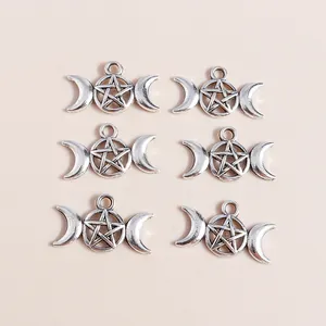 Macro detail of retro silver triple moon goddess charms with hollow star pendants