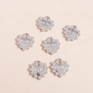 Set of six silver heart-shaped alloy pendants with LOVE engraving and floral edges