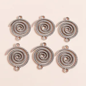 Detail of vintage spiral alloy charms in antique silver finish for DIY jewelry making