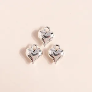 Detail of silver 3D heart charms with smooth mirror finish for DIY jewelry making