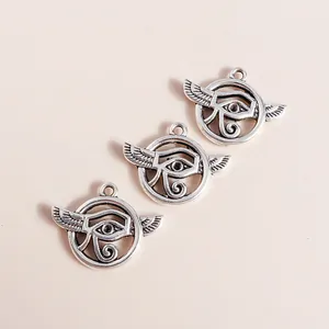 Detailed view of three vintage silver alloy hollow evil eye pendants for DIY jewelry