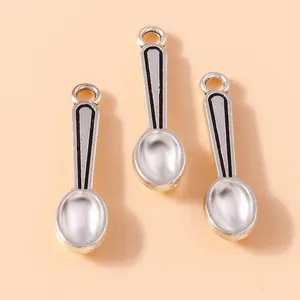 Macro shot of vintage silver-plated alloy mini spoon charms for DIY jewelry making