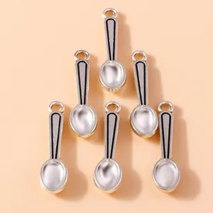 Detailed view of silver-plated spoon charms for DIY jewelry making and crafts