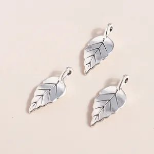 Detailed view of silver leaf alloy pendants with vintage texture for DIY jewelry making