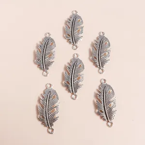 Retro silver hollow leaf charms for DIY jewelry making featuring vintage feather designs