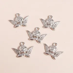 Five vintage silver alloy angel pendants for DIY jewelry making with classic wing details