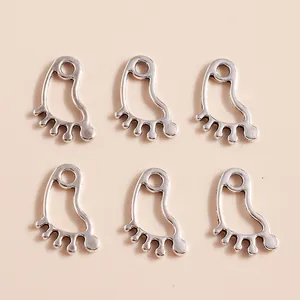 Detailed macro view of hollow paw print alloy charms with vintage silver plating for DIY jewelry