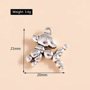 Macro view of vintage silver balloon dog charms showing 21x20mm size and 3.4g weight