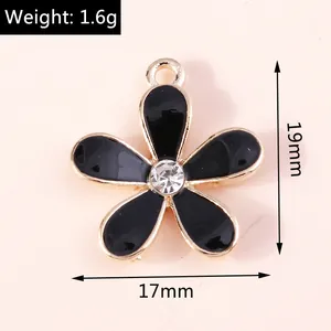 Detailed close-up of 1.6g black enamel cherry blossom charm with gold alloy trim