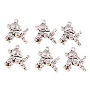 Macro view of vintage silver balloon dog alloy pendants with round hanging holes