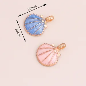 Detail view of blue and pink shell alloy charms with gold edges and 26mm size marking
