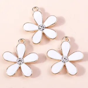 Three white enamel cherry blossom charms with gold trim and crystal center for DIY jewelry