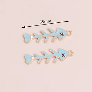 Detailed view of 35mm blue enamel fish bone pendant with gold alloy trim for DIY jewelry